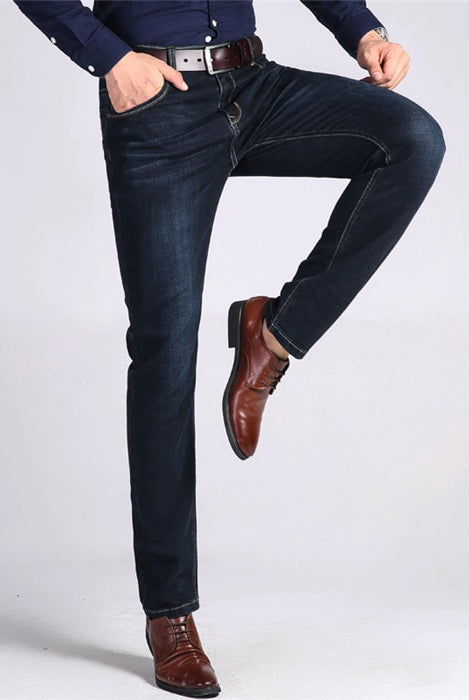 Stretchy Dark Blue Men's Jeans with leg lifted up.